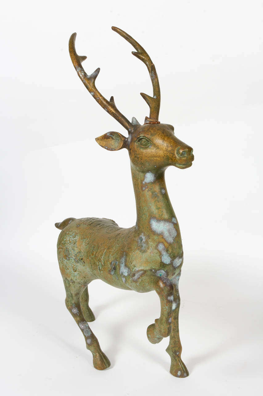 A bronze deer statue with auspicious Chinese characters embossed to the surface.  These characters represent blessings of long life, prosperity, wisdom, protection and good fortune.  Early 20th century, cast bronze with embossing.  Wonderful patina,