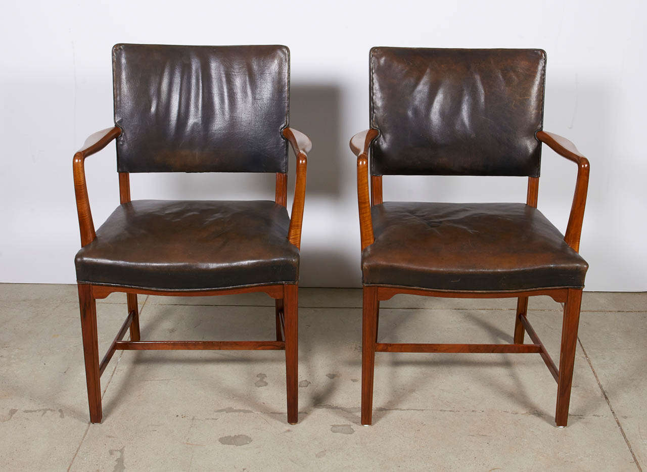 A pair of Danish open armchairs, Circa 1930-1940, Beechwood and other with original leather upholstery. Probably produced by C.B Hansen, Copenhagen.

With rectangular backrests, curved armrests, tight upholstered seat raised on square legs with