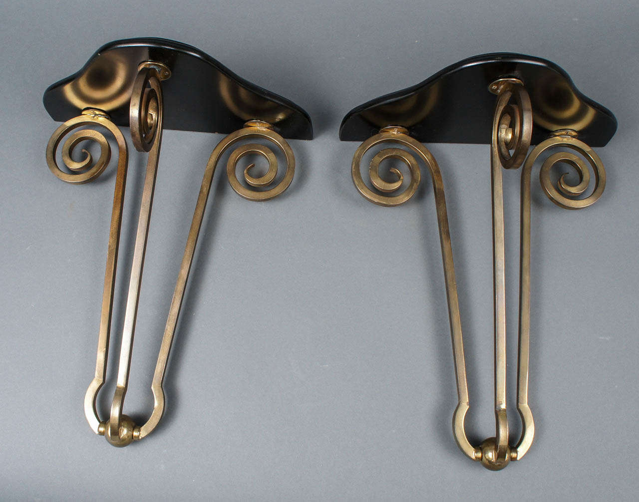 Pair of Italian Wall Brackets.  Black lacquered triangular top over brass tripod base.