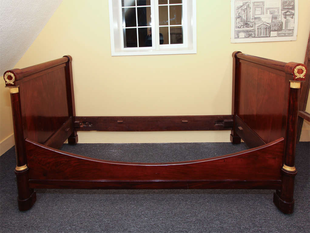 French Empire Mahogany Daybed

This is a First Empire bed with original bronzes.  It is a nice medium color with a good French polish finish.  

It is made with beautiful woods.  For example the end panels are made from two wide boards of solid