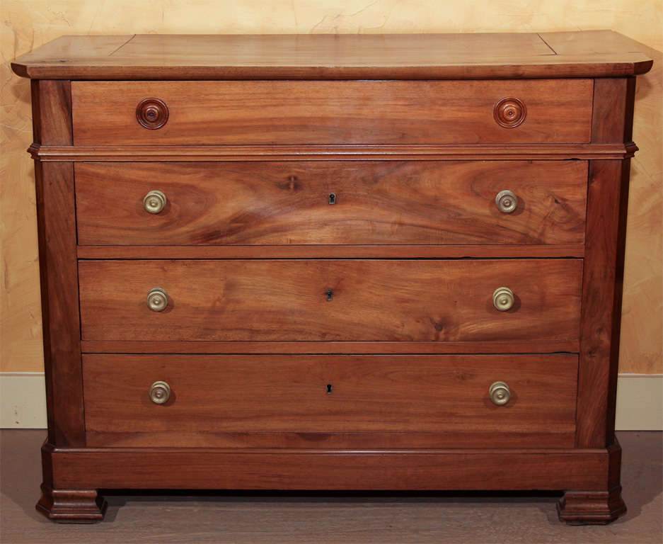 French Walnut Commode 

This is a simple French chest with four long drawers. The The top drawer has the original carved wooden knobs. 

The six bottom knobs are reproductions in the Empire style.  The top, sides and front are all solid walnut.