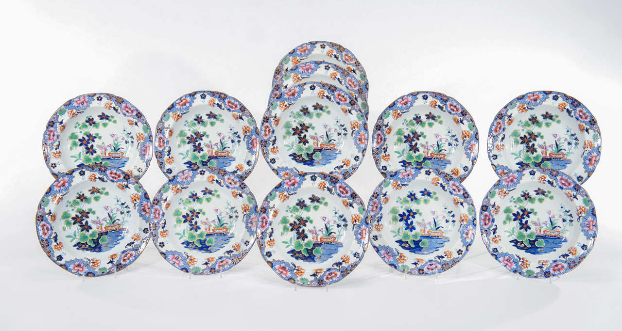 This set of 12  early 19th c. Spode rimmed soup bowls are transfer decorated with  hand painted vibrant enamel colors which are sure to work with many palettes and styles. In the Japonesque style, so popular in this period, these embody the