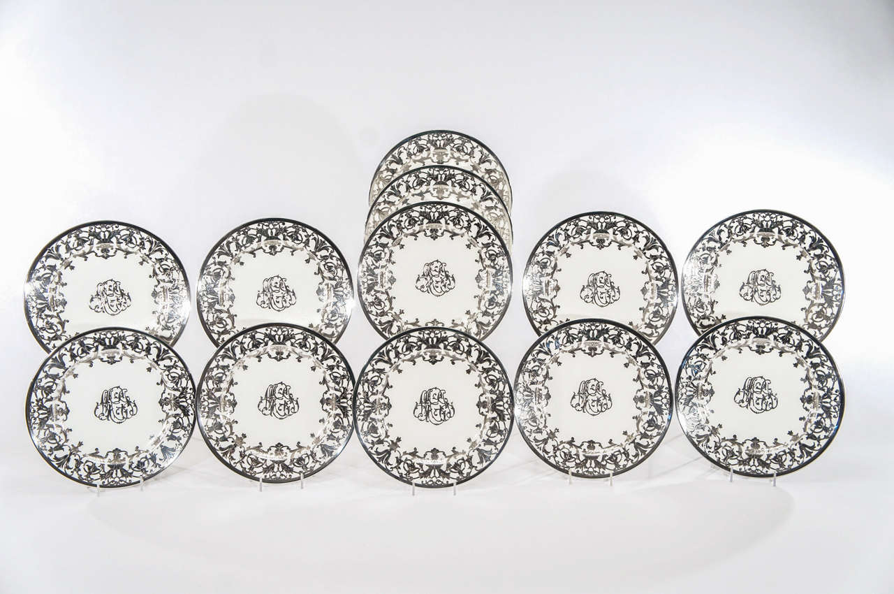 This set of 12 Minton service plates is a rare example of Minton's sterling silver overlay. Most silver overlay was made by other porcelain manufacturers and these were surely a custom order. The thick, heavy and profuse silver work, extremely