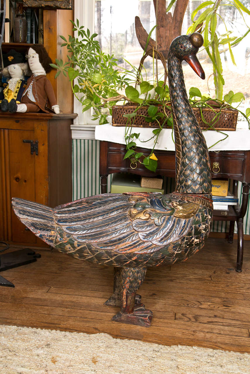 Grand and important hand carved wooden goose. Deeply carved
painted and gilted regal looking bird. Probably made in Siam in early
19th century. Peeled paint in green, blue, black, red and gold.
Head amd neck are a separate piece that have a