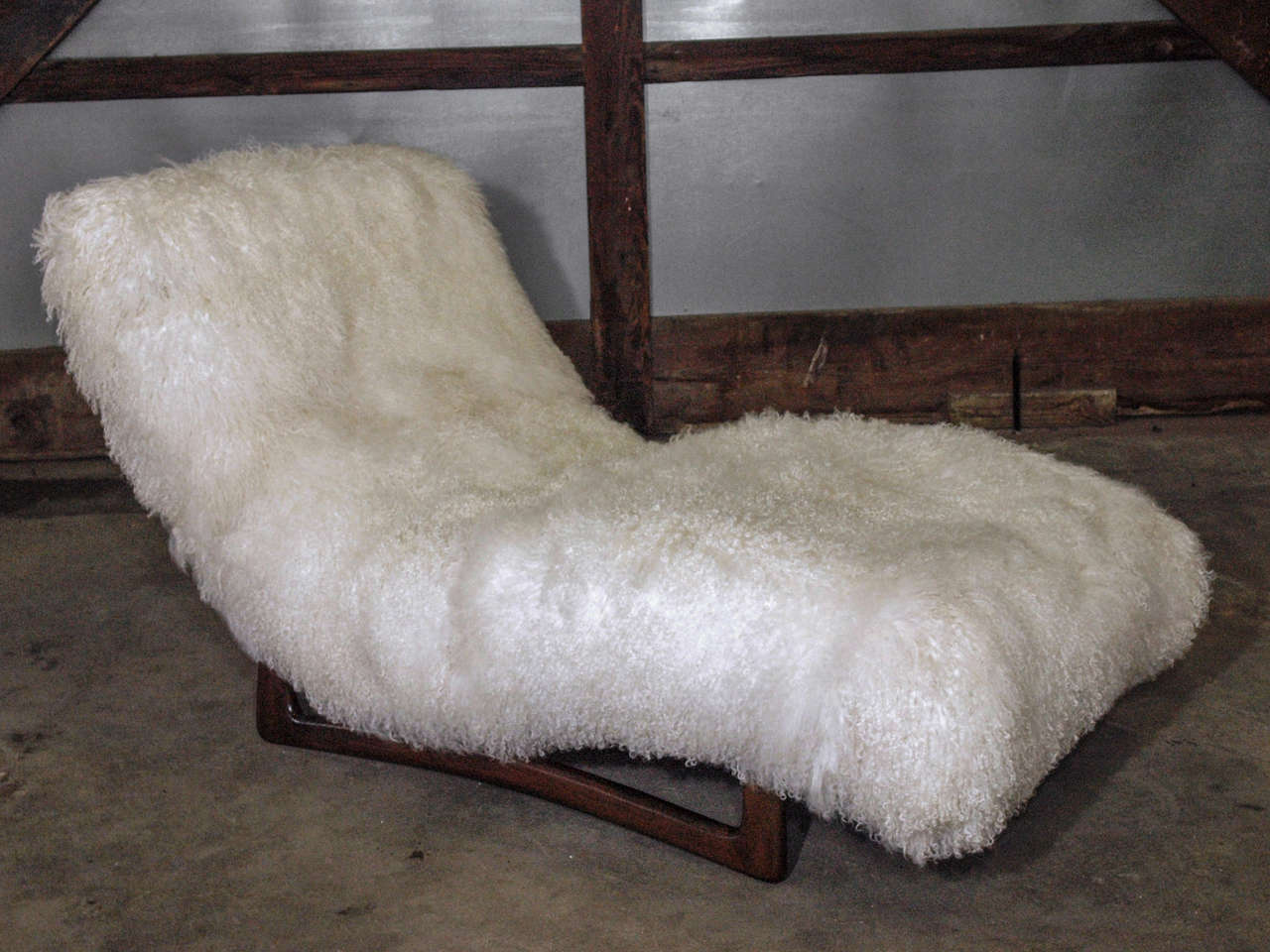 Elegant, curved Chaise Lounge with sculptural walnut base by Adrian Pearsall for Craft Associates. Excellent restored condition and newly upholstered in soft, silky and luxurious Mongolian goat hair on hide from my own country of Argentina.  Ideal