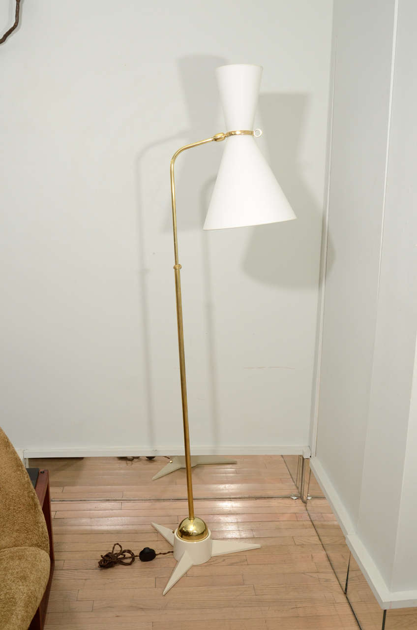 Fantastic floor lamps by Robert Mathieu, the brass stem anchors into a ball that rotates in a cast iron star shaped base. New wiring and shade, all original patina on metal. Price is for one.