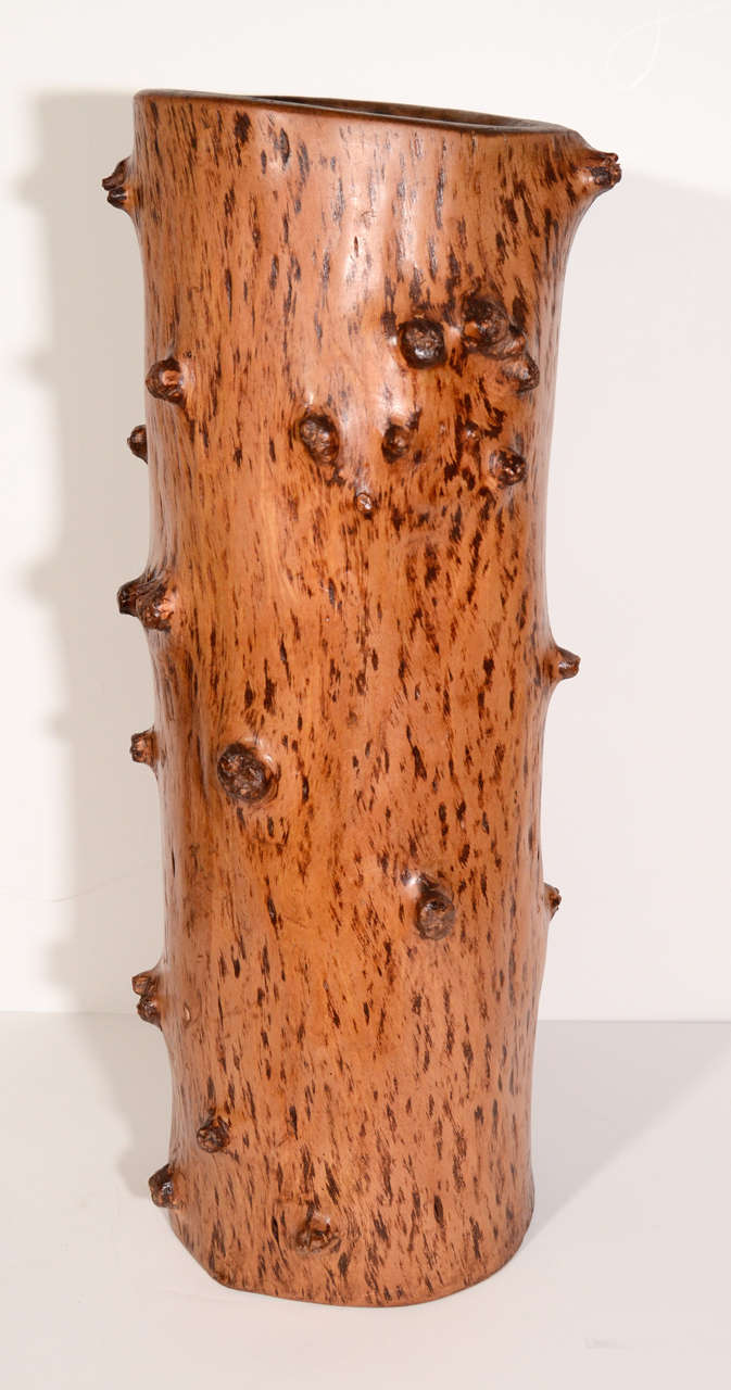 Vintage umbrella stand or planter made from North American spruce tree trunk. The umbrella stand features a free form shaped with hollow center and has knotted details throughout with hues of medium browns.  Smaller (Shorter Version) umbrella stand