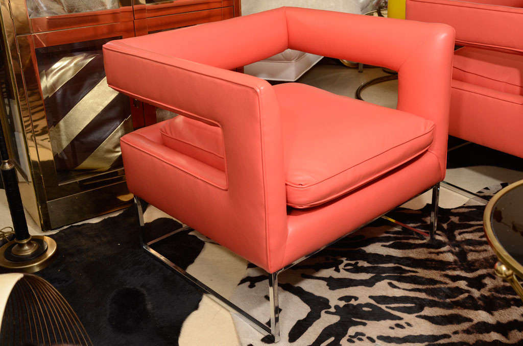 A handsome pair of club chairs by Milo Baughman, C 1960. Redesigned in coral ultra leather, (faux), washable.