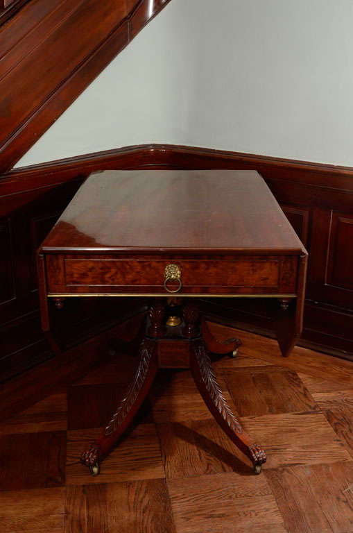 This elegant drop leaf table exhibits a number of characteristics connected with New York City furniture in the
Federal period: The canted-corner drop-leaves, pendant finials, quatripartite supports and splayed legs are details similar to those