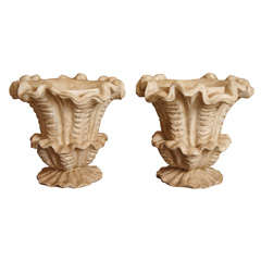 Four Rococo-style cast stone urns
