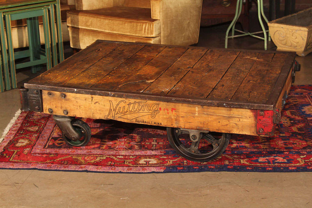 Refinished Factory cart, cast wheels outlined with rubber, top bordered with steel