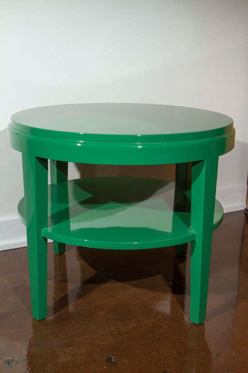 Pair of classic round side tables with shelves, recently refinished in a rich Dorothy Draper-inspired green lacquer.