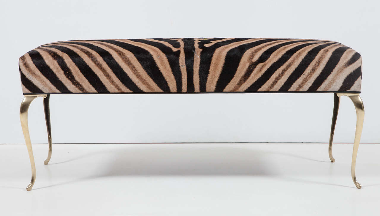 Beautiful zebra bench with brass legs.