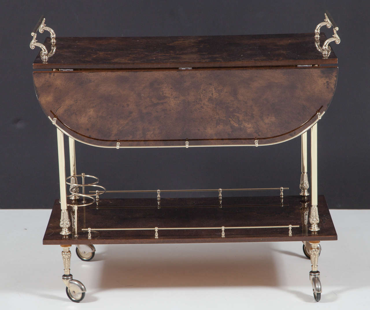 Beautiful goatskin parchment bar cart with brass details by Aldo Tura, circa 1950, Italy. Excellent condition. 
The bar cart is 27 inches high and with the handles it is 29.5 inches high.