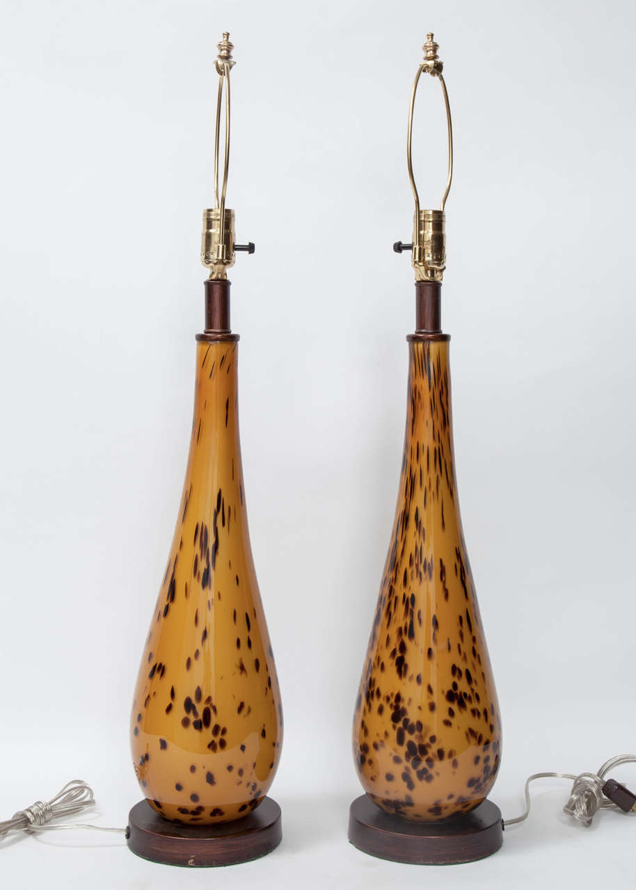 A unique pair of lamps in Murano glass with a tortoise shell pattern on the original wood base. The lamps have been recently re-wired.