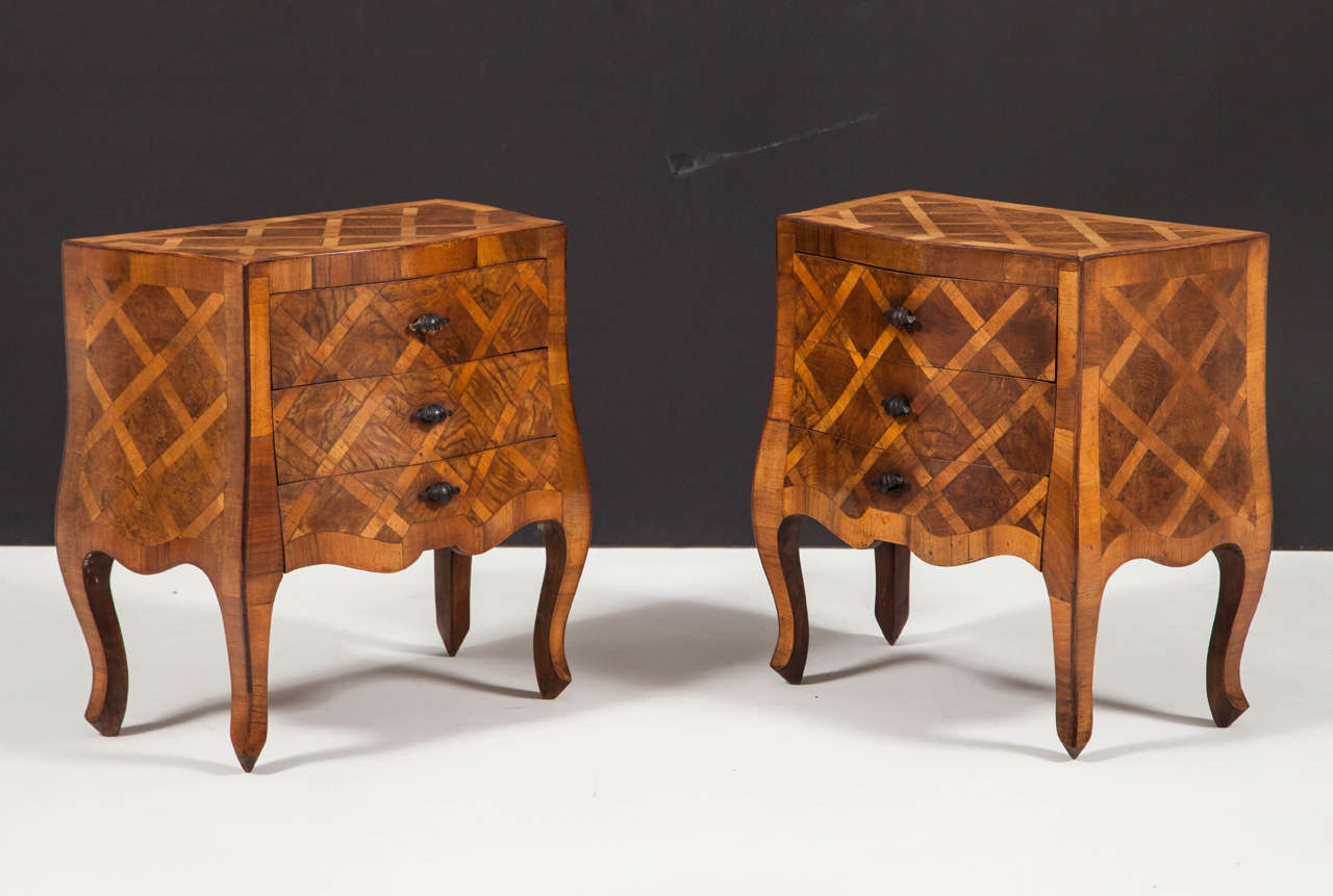 Petite three-drawer bombé commodes completely veneered in walnut and walnut burl geometric marquetry, including the backs. Great mellow color and original finish, with dark bronze shell-shaped pulls, Italian, 1950s.