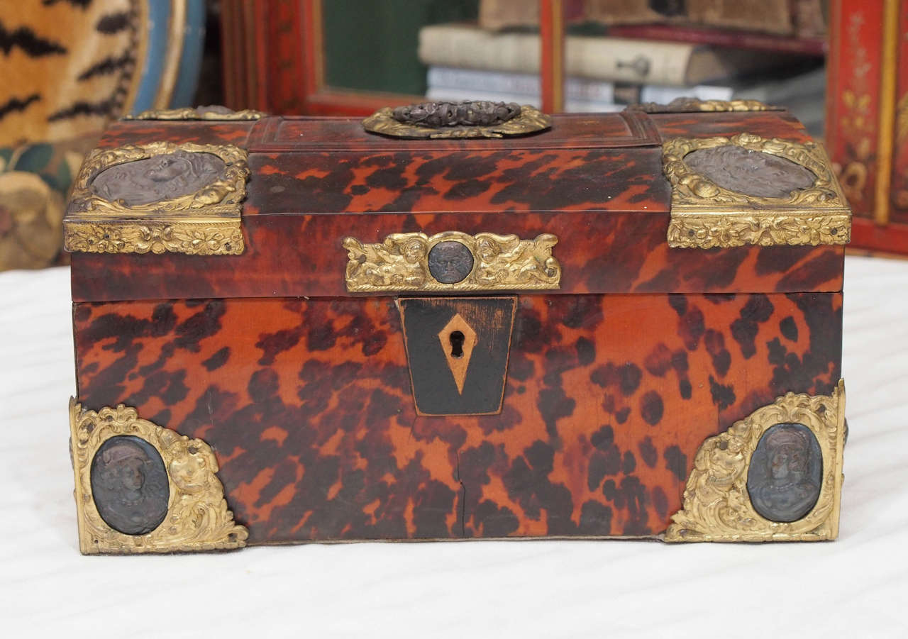 Swedish 18th c. Tortoiseshell and brass document box with medallions on each corner and molded tortoiseshell on the top. It includes a note inside about ownership in Swedish.