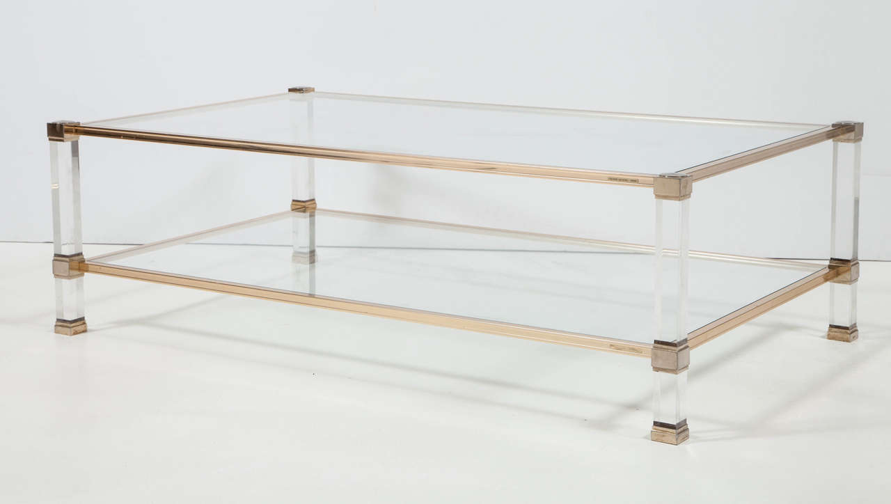 Designed by Pierre Vandel.
Gilded metal.
Clear Lucite legs.