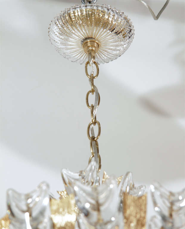 Stunning Lobmeyr chandelier with multiple shield-form crystal prisms and gold-plate quill-form accents.  Bears six lights and original crystal ceiling canopy.