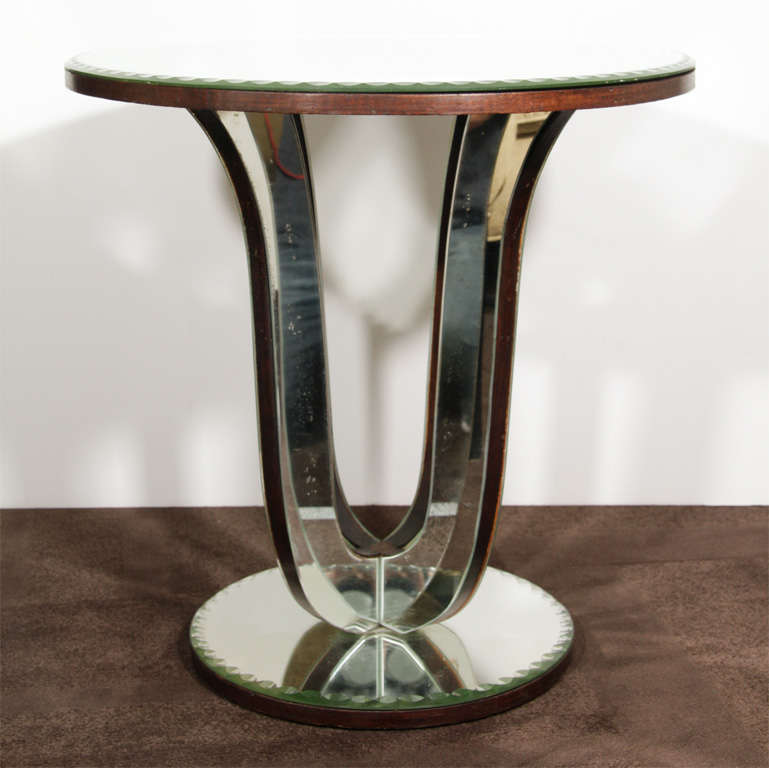 Classic Art Deco mirrored side table with tulip-form base and ebonized walnut trim.  Features all original antique mirror with hand-beveled chain motif borders on top and base.