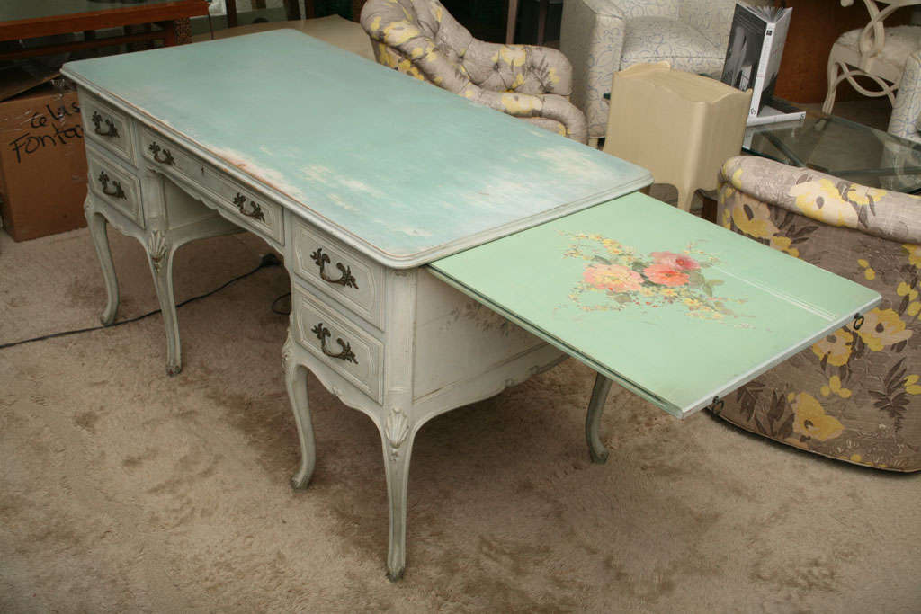 Pale blue desk with five drawers and two pull-out shelves. Painted floral decoration on each side of the desk, as well as on the tops of the pull-out shelves. Lovely carved shell decoration on each knee of the tapering cabriole legs. Beaded scrolled