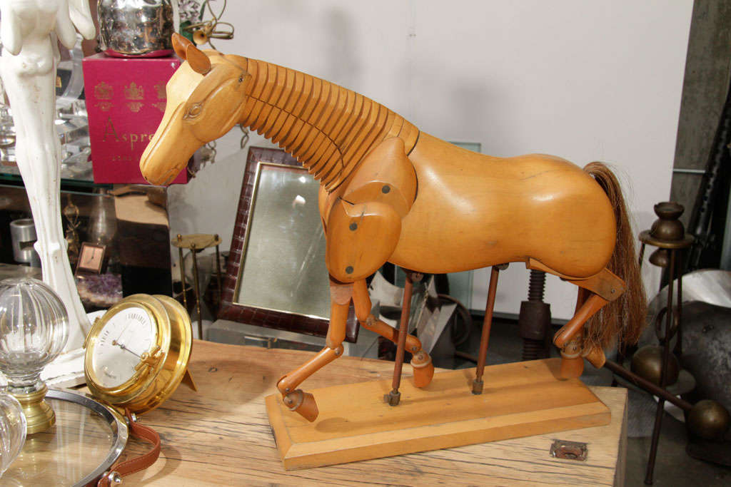 This is a wonderful example of an articulated horse Lay figure. These are typically found in dark woods making this version quite unusual. It is on its original adjustable stand