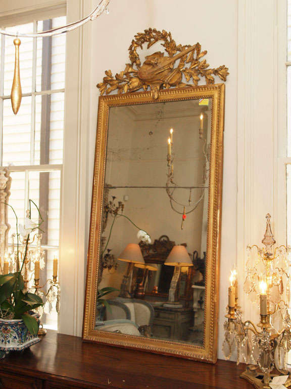 18th century Louis XVI gilt trumeau with mirror in two parts.