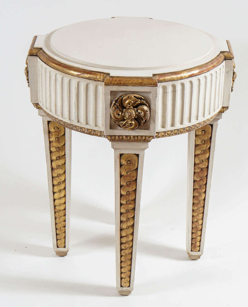 Exquisite neoclassical Napoleon III period French parcel-gilt and painted solid oak gueridon or occasional table having breakfront circular top with raised central plinth surmounting thick fluted apron with high relief carved rosettes in corner