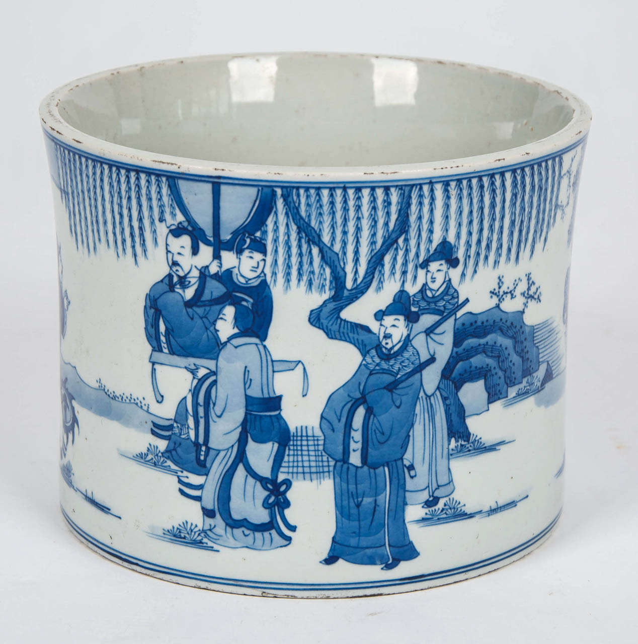 Beautifully painted in varying shades and tones of under-glaze blue showing figures in an imperial courtyard scene. There is also a figure with a bull to one side.

The piece has a small circular indentation on the base which is a typical feature