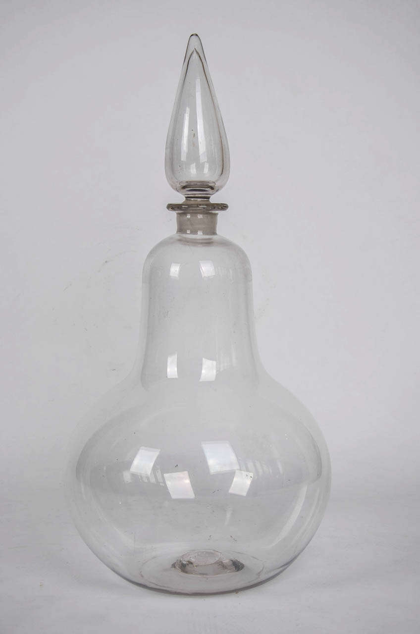 This is a superb and very large Hand Blown Glass Jar as found in some English Chemist Shops in the late 18th / early 19th Century.

The Jar is Pear Shaped with a formed rim into which the original conical stopper fits. The base of the jar has a
