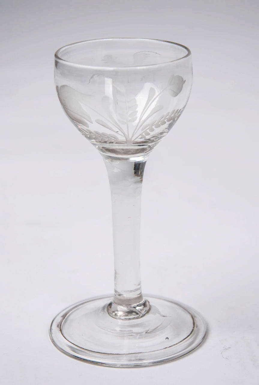 This is a fine Hand Blown, English,  MEAD GLASS from early in the 18th Century, Circa 1740. 

This drinking glass is made from Lead Glass and has a good drawn CUP Bowl engraved with a pheasant in flight and two flower buds of which one is an acorn