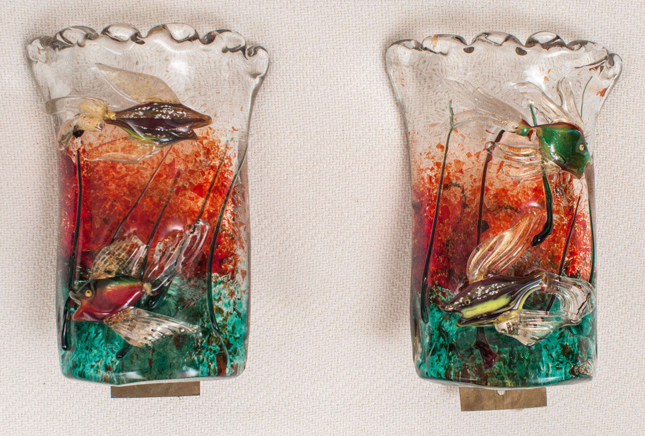 Featuring swimming tropical fish in low relief on an emerald green and coral red background.