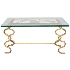 A 1950s French Thick Glass and Gilt-Iron Cocktail Table A 1950s French Thick Glass and Gilt-Iron Cocktail Table