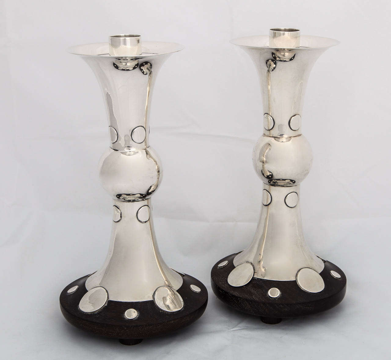 An important pair of taller sterling silver and rosewood candlesticks by William Spratling. Hand hammered silver signed on the underside with the spratling mark.