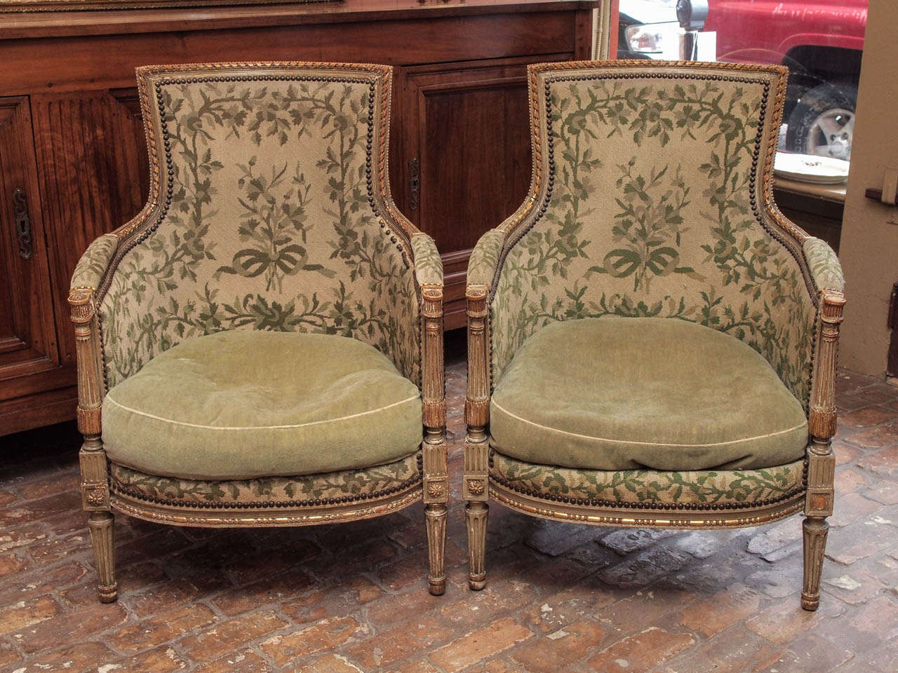 Pair of 19th century French painted and gilded bergeres in the Louis XVI taste, circa 1860.