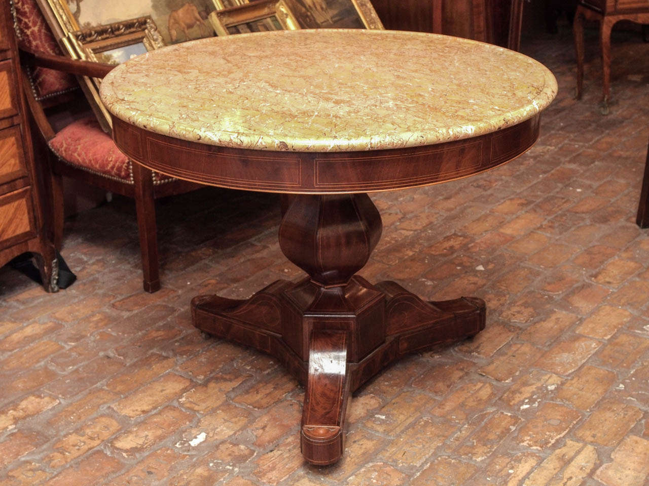 French Charles X period mahogany gueridon with satinwood inlay and unusual marble top, circa 1830.