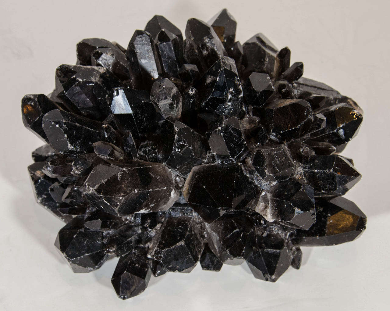 Stunning decorative object comprised of natural and rare black quartz crystals. The top half of these extraordinary large chunks of crystals can be lifted to reveal an interior center box or compartment, lined in a rich black felt fabric. The bottom