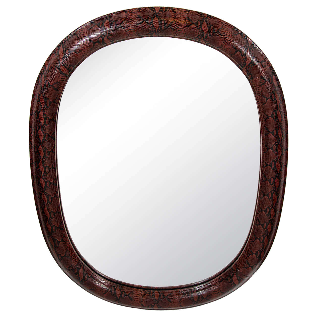 Stunning mid-century modern rounded mirror with slight oval form. Wrapped in red and black snakeskin print embossed leather. Leather over hand-carved wood with half round molded frame. In the style of Karl Springer.