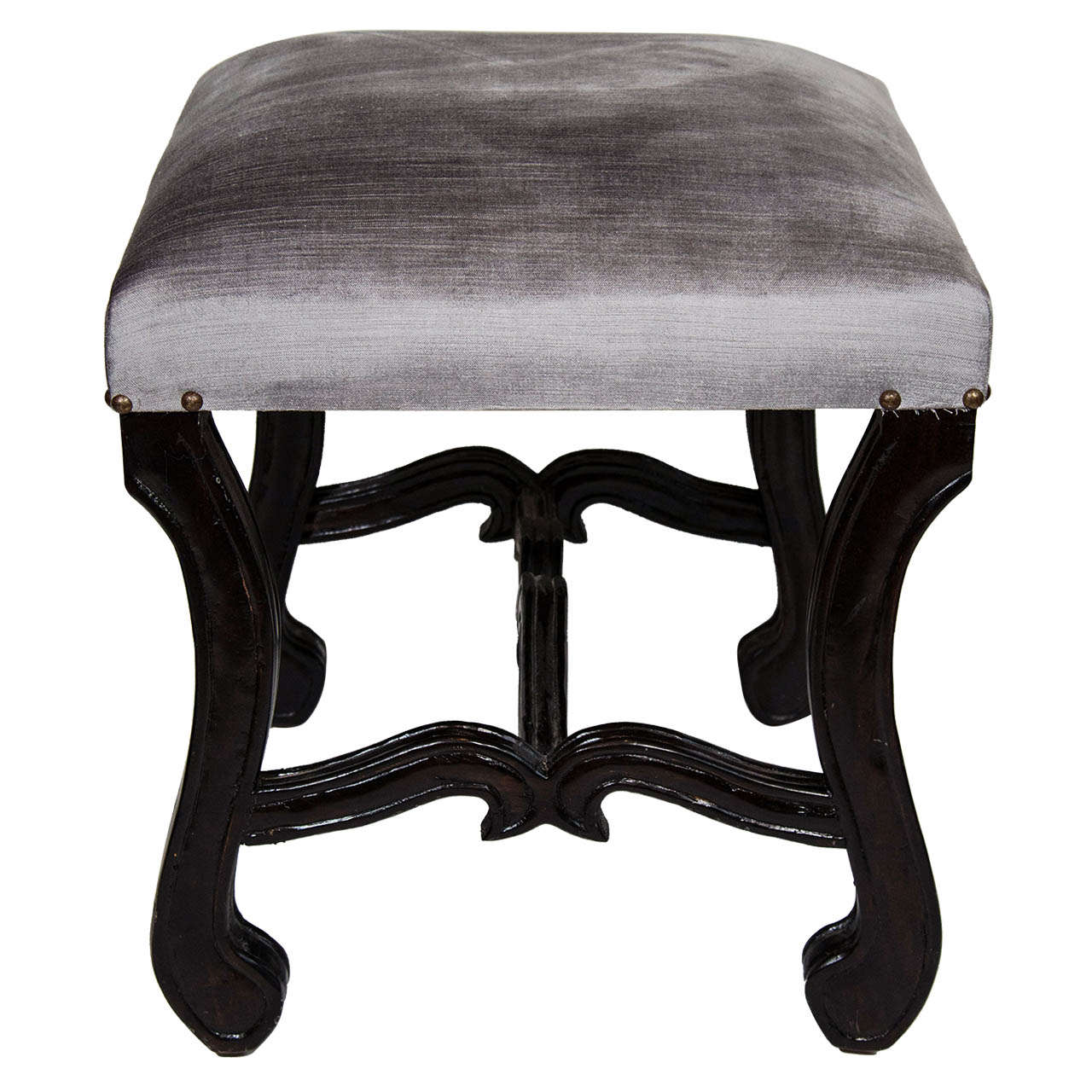 Elegant mid-century vanity stool with hand-carved walnut wood base in ebonized finish. Newly upholstered in luxe grey velvet with antique brass stud details. The bench features scrolled cabriole leg design and stylized cross stretcher with carved