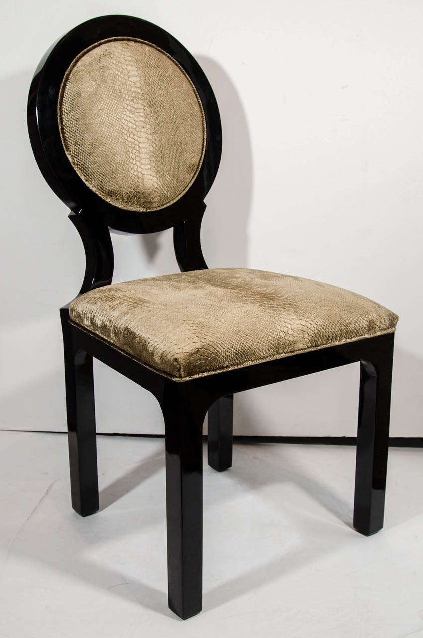 Art Deco side chairs with neoclassical inspired round back design. The chairs are finished in a rich black lacquer and have been upholstered in a luxe velvet-mohair fabric with an embossed python print pattern in vibrant hues of taupe or mushroom.
