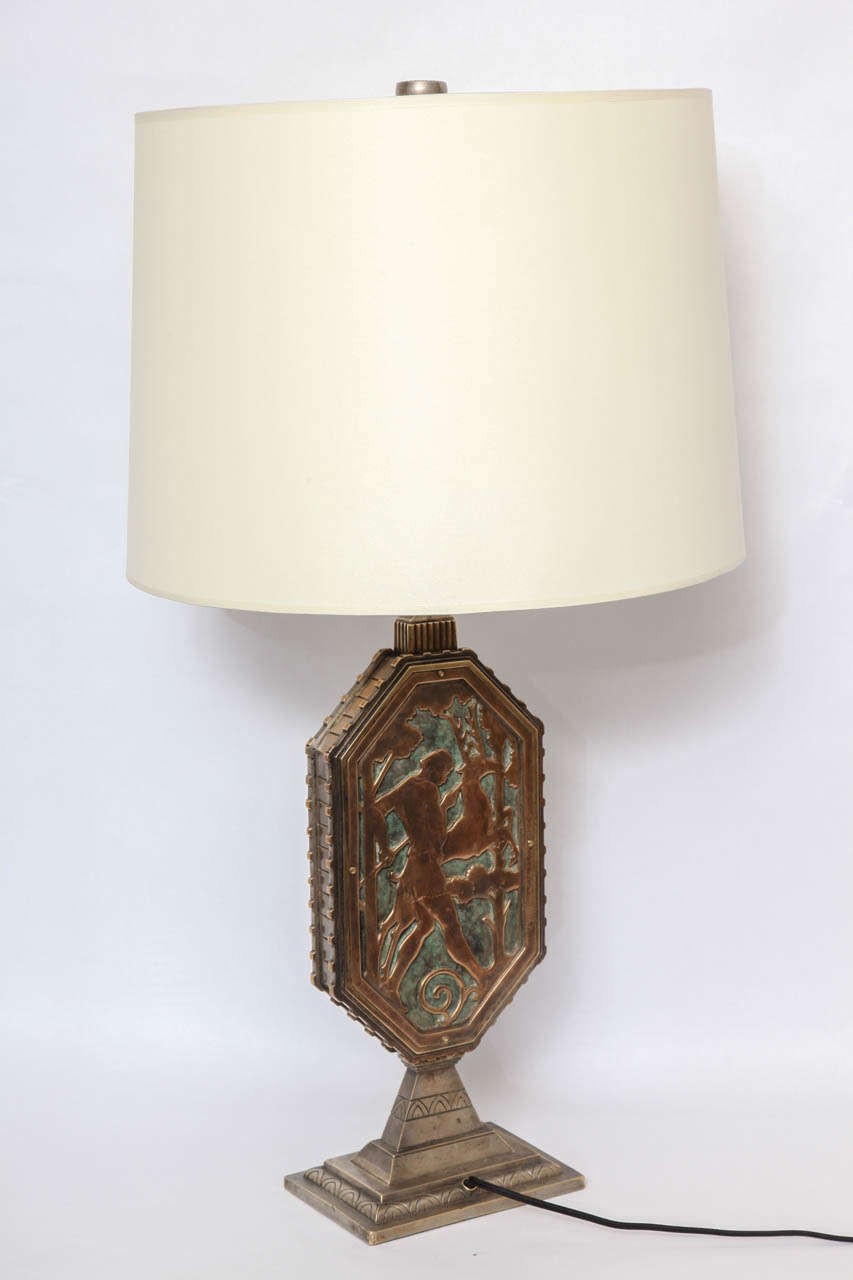 A modernist art deco table lamp by Oscar Bach, produced circa 1920s, with octagonal form body, crafted of patinated brass, silver and verdigris patina. Markings include signature [Oscar B Bach] stamped to applied tag.