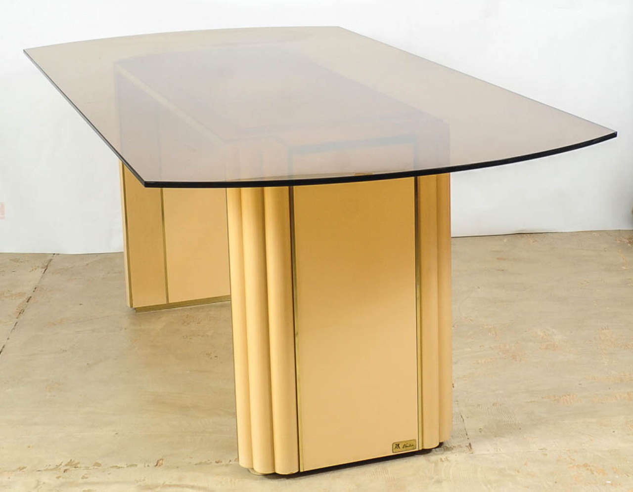 Very elegant dining table in ivory lacquered wood and polished brass designed by Alain Delon for Maison Jansen. The table top is made of smoked glass in a semi oval shape.
French super star actor Alain Delon (born 1935) turned his talents to design