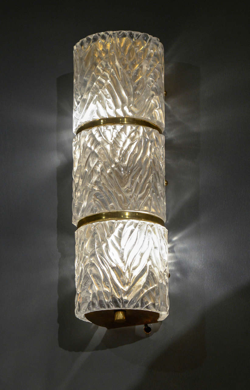  14 wall sconces made of textured Murano glass and brass details.
Two lights per sconces, new electrification.