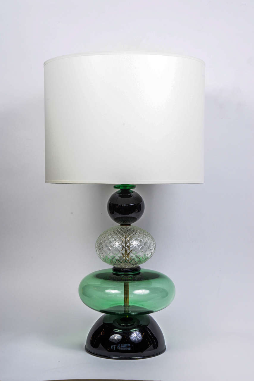 Nice pair of lamps made of differently shaped Murano glass parts, each in a different shade of green and one transparent textured part in the middle, in the style of Venini.

New electrification, perfect condition.