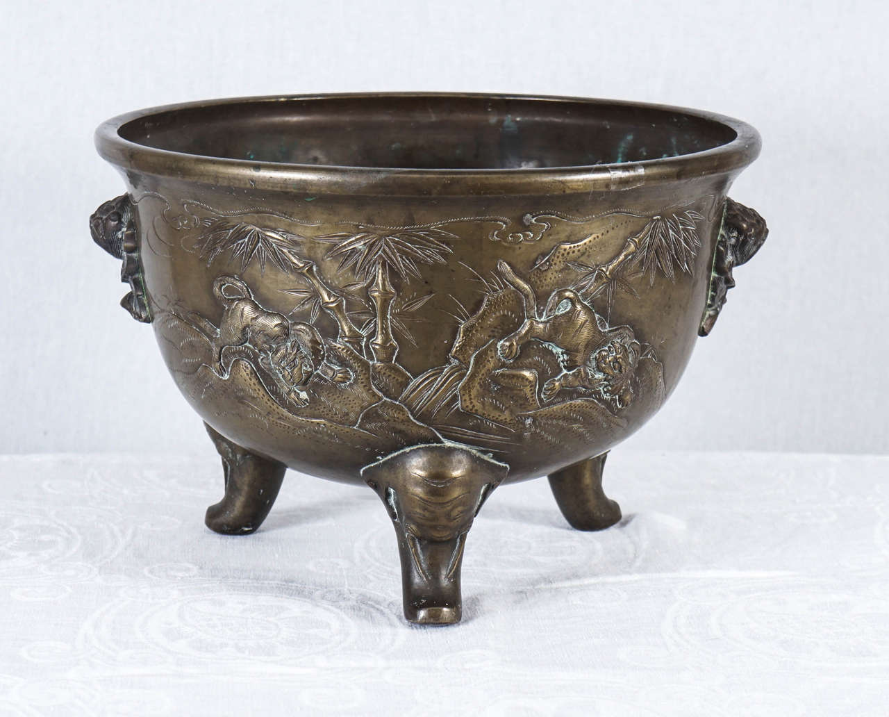 This deeply cast Japanese bronze planter was made in the Meiji period, a time in Japan when the natural order of life was upset by the disbanding of the traditional samurai class. Skills used to create objects for this class were turned to domestic