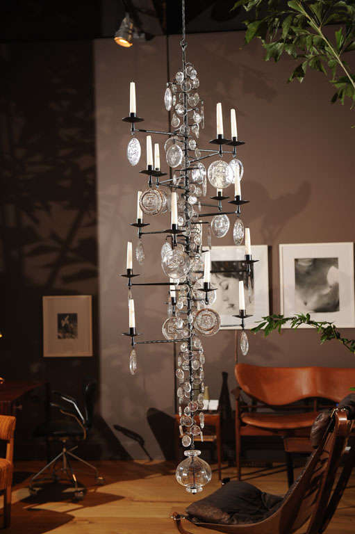 A hanging candelabra/chandelier made of wrought iron and glass, Boda Nova Glassworks/Axel, Stromberg Ironworks, not wired for electricity. 

**Only one of these is available.**