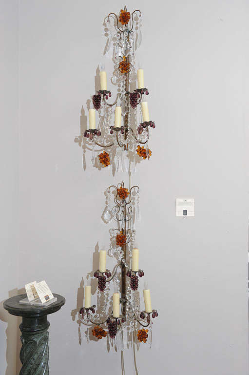 Turn of the century pair of French, five-light, three-tier, bronzed appliqués with hand-cut crystal pendulums and amber and amethyst glass grape clusters. Now electrified with beeswax candle covers.