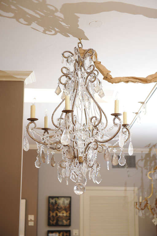 Mid 20th century Italian neoclassical style arm chandelier. The scrolling corona above lyrical supports culminating in six arms. The armature totally beaded with hand cut faceted center crystal finial. The whole with rock crystal smokey topaz and