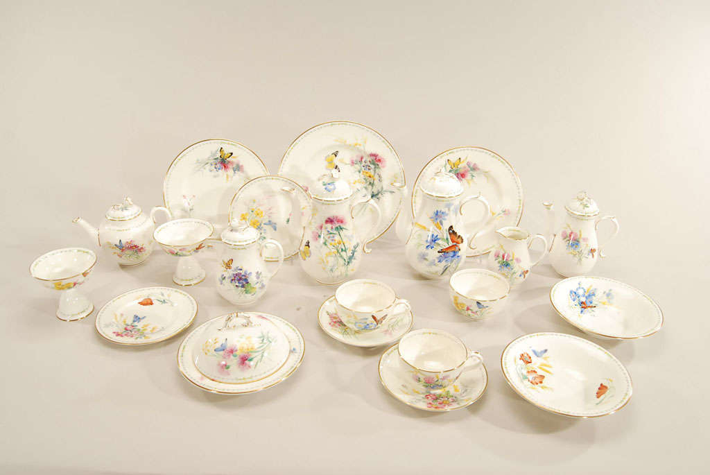 It doesn't get more complete than this full breakfast service for two. Each piece is uniquely painted in a bright and cheerful palette of flowers and butterflies. The decorative and practical service includes cups and saucers, side plates, 9