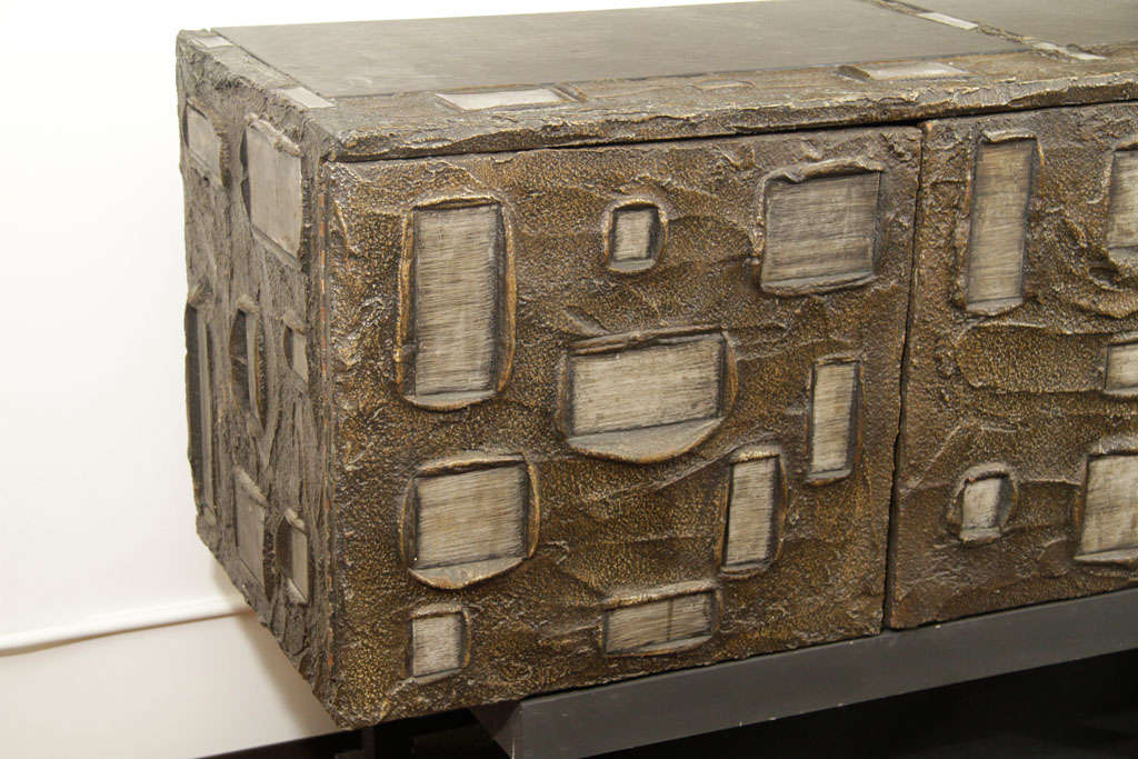 Sculpted wall mount cabinet by Paul Evans made for Directional signed PE 69. Crafted in the 1960's this superb hanging sideboard has a magnificent sculptured front made of welded and enameled steel, bronzed resin and slate. <br />
It has a custom